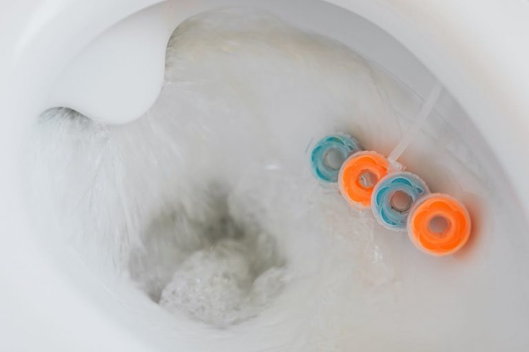 Cleaning blocks under the rim of a toilet bowl